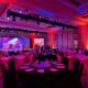 Corporate event production setup in Dubai ballroom with LED stage wall, professional lighting rig, and banquet seating by Pure Magic Events
