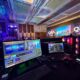 A behind-the-scenes view of a professional event production setup in a large, modern conference hall.